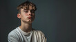 © Graphic Resources - Casual headshot of a defiant teen boy with his arms crossed on a solid studio background