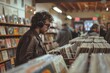 © Woraphon - A man wearing a leather jacket is browsing through a record store