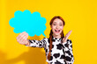 Photo of positive impressed woman wear cow skin print top rising talking cloud empty space isolated yellow color background