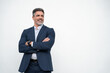 © Stock 4 You - Smiling confident latin hispanic mature business man standing crossed arms isolated on white background. Older senior businessman professional ceo, coach, leader looking aside. Banner, copy space