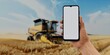 Hand with smartphone in wheat field, perfect for agricultural tech promotions