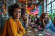 © Vilaysack - Creative team meeting at a round table in a vibrant coworking space, multi-ethnic group, casual wear, sticky notes and digital tablets on the table, dynamic angle,