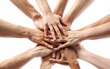 Closeup view of people stacking their hands together for unity and teamwork on white background