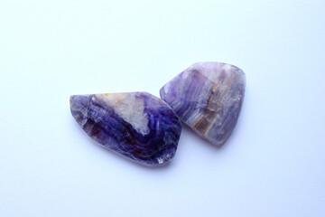 Wall Mural - Close-up sections of beautiful striped purple fluorite on a white background. Healing Chakra Crystals