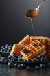 Belgian waffles with fresh blueberries and caramel sauce.