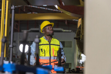 Black man factory worker working in metal sheet manufacturing industrial