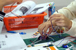 Students experiment with simple electronic circuits. Principles of traffic light circuits. Soft and selective focus.