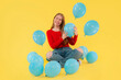 © Iryna - happy woman with balloons on yellow background