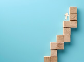 Top view of wooden block step stairs with arrow line for business growth concept on blue background, in the simple and minimal style