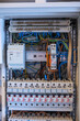 © karegg - An electrician works on a fuse box