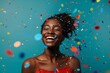 young smiling black woman in casual clothes studio shot with a bit of confetti