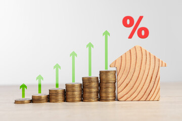 Wall Mural - Mortgage rate. Wooden model of house, stacked coins, arrows and percent sign