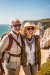 A couple of older tourists are walking near the cliff. Positive tourists. Generative AI.