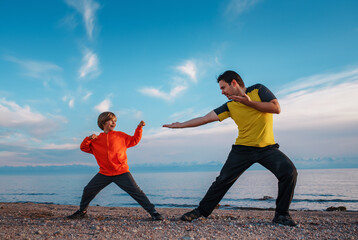 Poster - Father and son martial arts training on lake shore