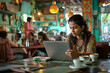 © wolfhound911 - An Indian woman engrossed in her laptop work at a vibrant cafe, illustrating the convenience and adaptability of remote work culture.