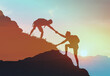 Team work, life goals and self improvement concept. Man helping his friend climbing partner up a steep edge of a mountain.	