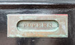 Antique newspaper mail slot in door