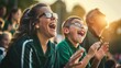 © Buzz Media - Parents and kids watching youth sports game, in the crowd at stadium cheering family playing baseball soccer field sport