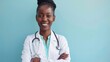 © NansiPhoto - Portrait of african middle age female doctor with stethoscope on blue background. Space for text