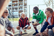 © Davor - Senior friends playing soccer together in urban park
