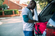 © Geber86 - African American man packing sports equipment into car after workout