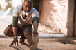 © Geber86 - Active young black man stretching on the street