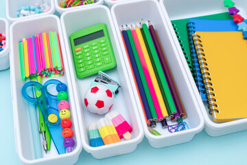 School supplies.Concept back to school. colored stationery is arranged in white organizers. Creative Drawer Organizing. Storage office supplies.