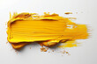 A yellow paint brush stroke on a white background