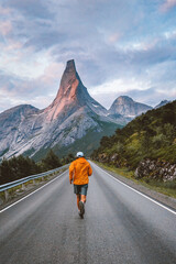 Wall Mural - man running on mountain road in norway travel adventure active healthy lifestyle outdoor summer vaca