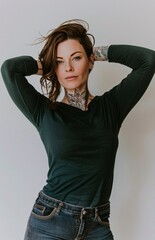 Wall Mural - photo of a white woman with tattoos and dark green long sleeves