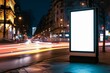 Mockup. Blank white vertical advertising poster billboard standing in city at night. Digital screen display lightbox for advertising or information on modern city street