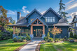 © Bashi Ai - The elegant frontage of a rich indigo craftsman cottage style house, featuring a triple pitched roof, bespoke landscaping, a welcoming path, and unparalleled curb appeal, signifying refined taste.