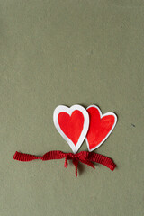 Sticker - two paper hearts and length of a ribbed red ribbon