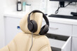 Dentist office treatment room has noise blocker headphones for the patient to relax with during teeth cleaning