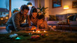 Warm and cozy scene of a family playing with candles together on the living room floor at night.
