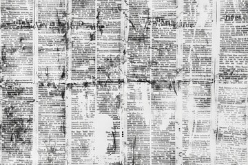 Wall Mural - An image of a wall covered with waste paper and old newspapers. Antique documents and dirty and torn printed writings.