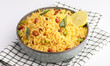 Lemon Rice or fodnicha bhat is South Indian turmeric rice or maharashtrian recipe using leftover rice garnished with nuts curry leaves and lemon juice, selective focus