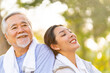 © CandyRetriever  - Asian woman daughter and elderly father resting after jogging exercise together at park. Retired man enjoy outdoor lifestyle sport workout in city. Family relationship and Senior people health care.