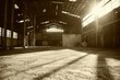 Large empty warehouse with sunlight shining through the windows.