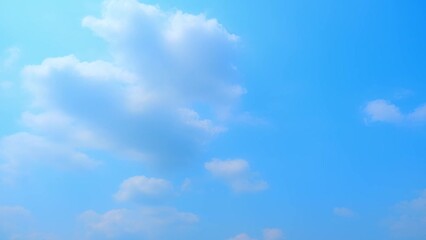 Wall Mural - Soft pastel blue skies and wispy white clouds come together in a 4K time-lapse video, presenting a serene and sunny skyscape that speaks of calm and beauty. Oxygen concept. Timelapse. Sky background.
