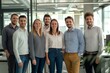 © yj - Happy business team standing together in the office, smiling at the camera. A strong, smart, confident group of professional businesspeople looking forward to success at a work meeting. generative AI