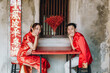 Happy young Asian couple in Chinese traditional dresses