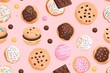 A colorful pattern of cookies and other baked goods on a pink background