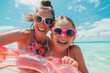 © ink drop - Mother and daughter in sunglasses with inflatable ring at beach, having fun on summer vacation