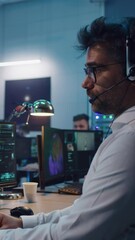 Wall Mural - Vertical shot of male operator using computer and speaking while launching spacecraft during work in flight control center