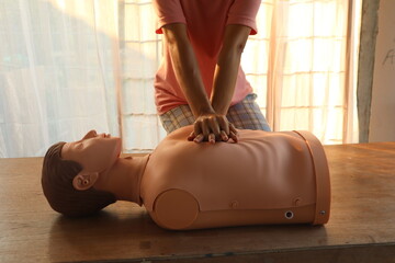 Close-up of CPR on doll's hand (Cardiopulmonary Resuscitation) A resuscitation technique used in emergencies to resuscitate a person who has stopped breathing or whose heart has stopped beating.