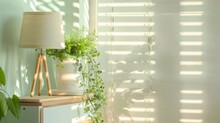 A Stylish White Wooden Cupboard, Adorned With A Fresh Plant And A Mint-colored Lampshade