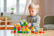 Little Child Playing with  Colorful Wooden Blocks. Toddler Building 