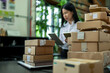 © Degimages - Ecommerce and website business, woman with a tablet, boxes and connection with communication, warehouse.