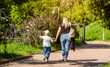 A woman and her son walks in the park
